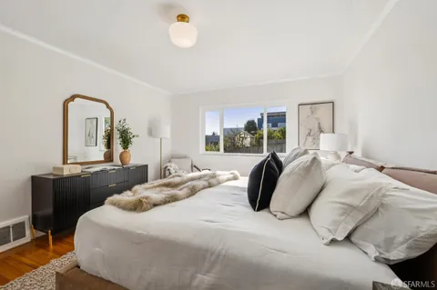 a bedroom with a bed and a dresser