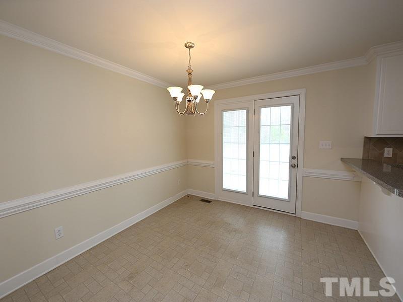 4689 Seven Paths Road Spring Hope, NC 27882 - Photo 4 of 12 en empty room with windows and chandelier