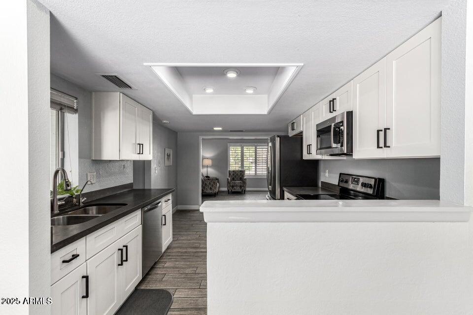 4909 East Waltann Lane Scottsdale, AZ 85254 - Photo 12 of 34 a kitchen with stainless steel appliances a sink stove and cabinets