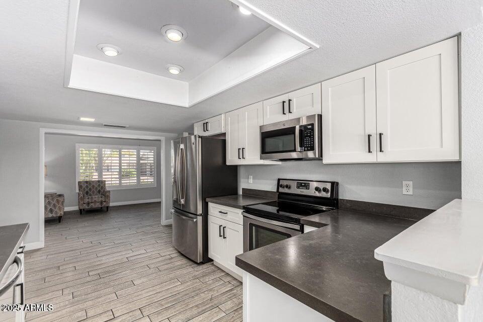 4909 East Waltann Lane Scottsdale, AZ 85254 - Photo 13 of 34 a kitchen with stainless steel appliances a stove microwave and sink