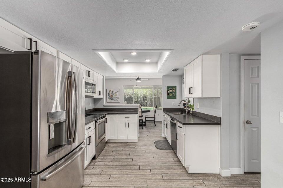 4909 East Waltann Lane Scottsdale, AZ 85254 - Photo 16 of 34 a kitchen with stainless steel appliances granite countertop a refrigerator a stove and a sink