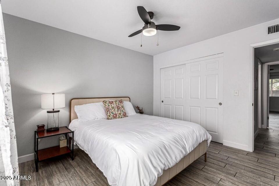 4909 East Waltann Lane Scottsdale, AZ 85254 - Photo 18 of 34 a bedroom with a bed and wooden floor