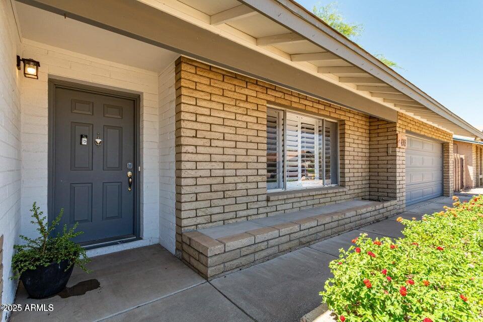 4909 East Waltann Lane Scottsdale, AZ 85254 - Photo 2 of 34 a front view of a house with a garden