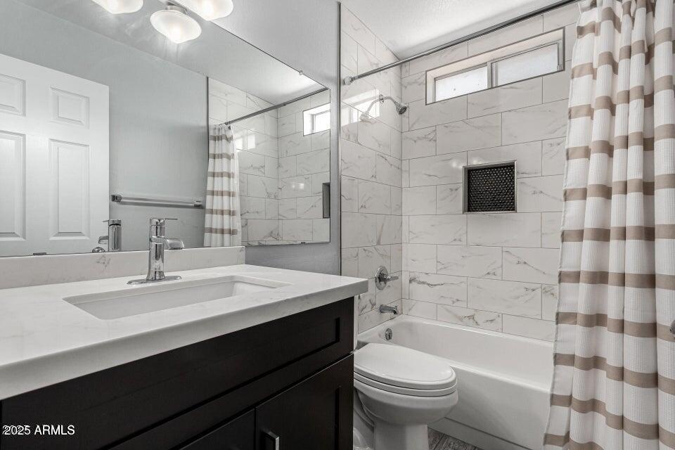 4909 East Waltann Lane Scottsdale, AZ 85254 - Photo 22 of 34 a bathroom with a sink a toilet a mirror and shower