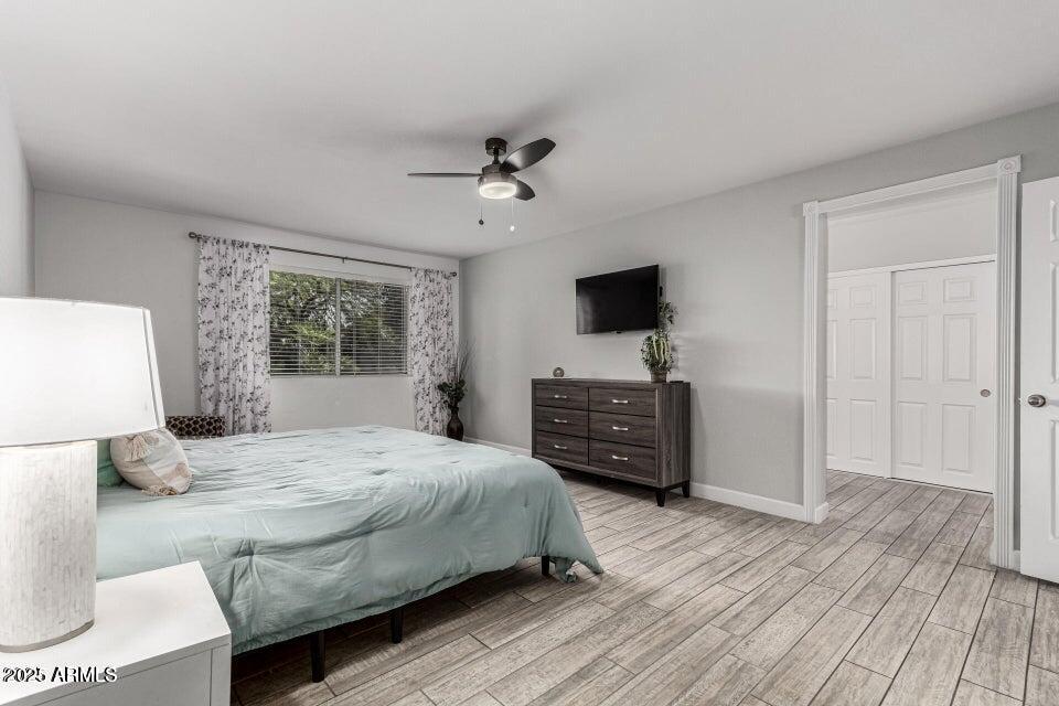 4909 East Waltann Lane Scottsdale, AZ 85254 - Photo 24 of 34 a bedroom with a bed and wooden floor