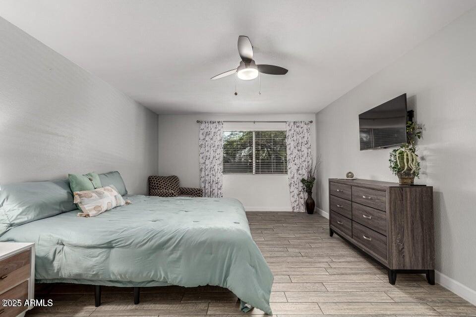4909 East Waltann Lane Scottsdale, AZ 85254 - Photo 25 of 34 a bedroom with a large bed and a flat tv screen on dresser