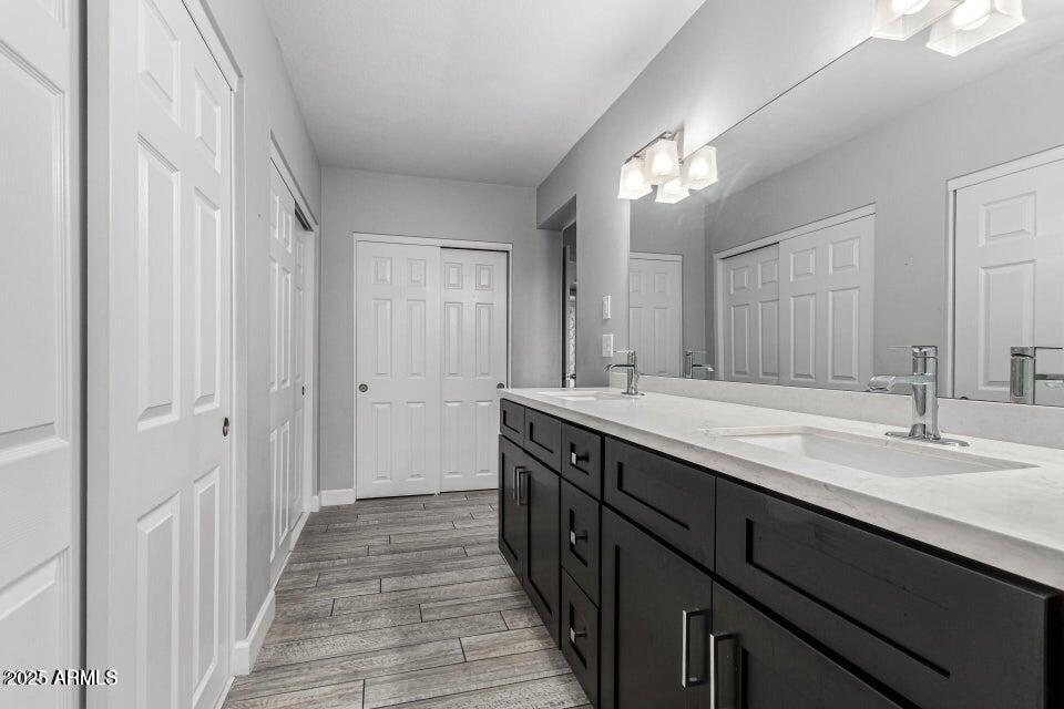 4909 East Waltann Lane Scottsdale, AZ 85254 - Photo 26 of 34 a bathroom with a double vanity sink and a mirror