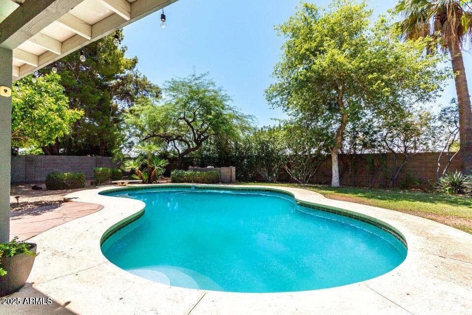 4909 East Waltann Lane Scottsdale, AZ 85254 - Photo 30 of 34 a view of a swimming pool with a patio
