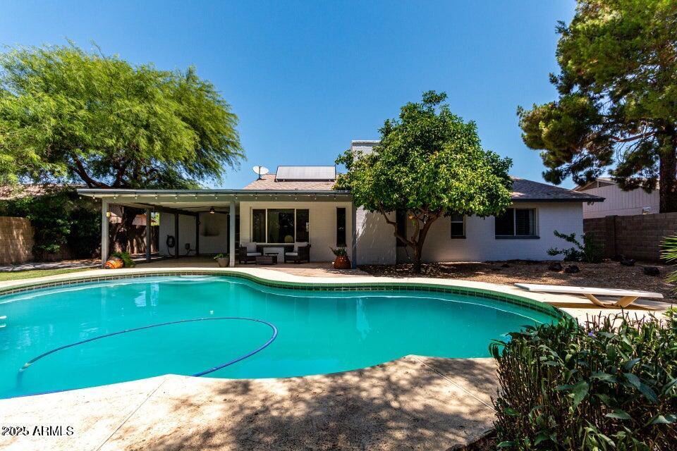 4909 East Waltann Lane Scottsdale, AZ 85254 - Photo 32 of 34 a view of a house with swimming pool and a yard