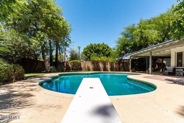 a view of swimming pool with seating space