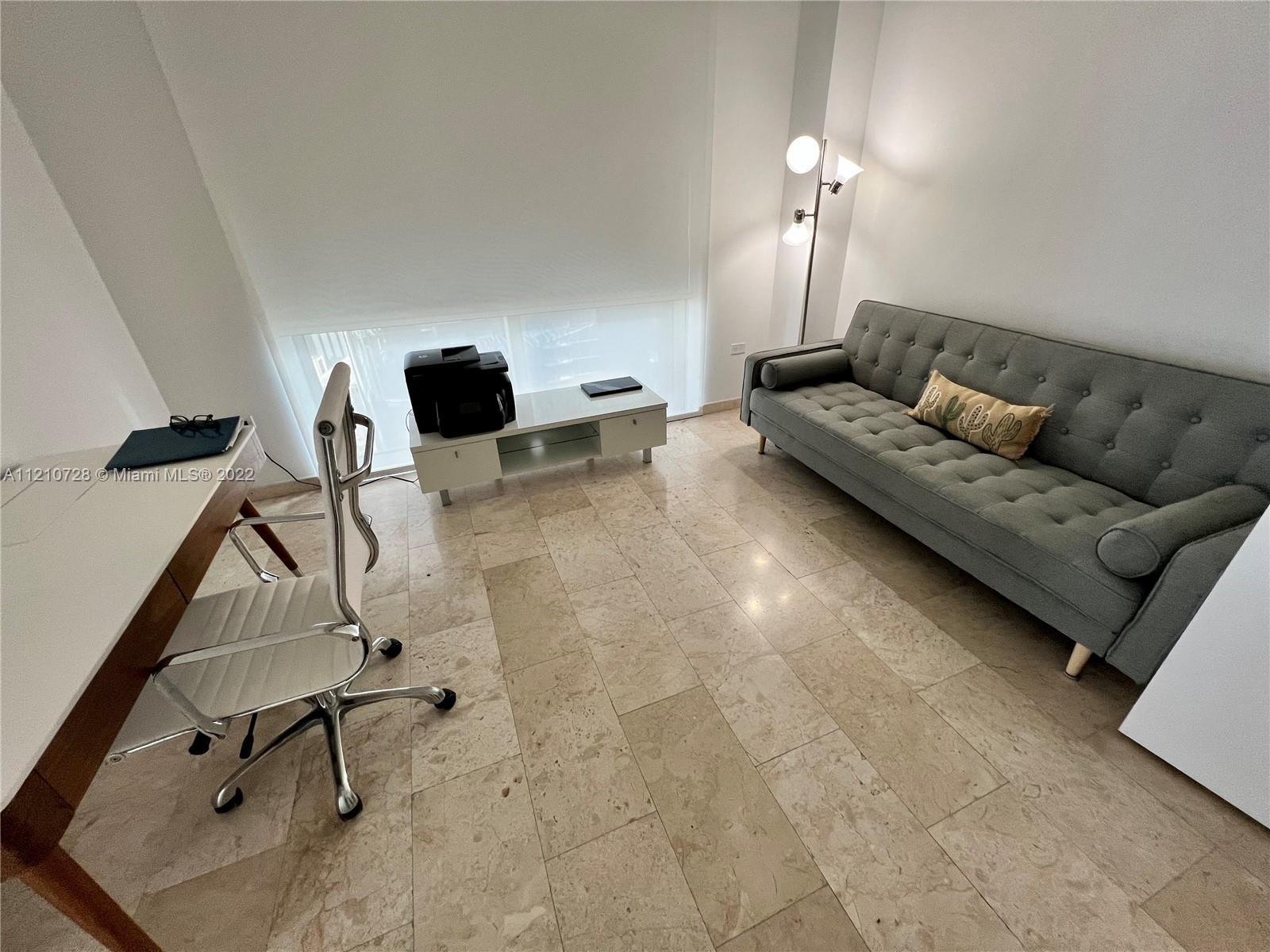 68 Southeast 6th Street, Unit 2801 Miami, FL 33131 - Photo 15 of 40 a living room with furniture and a gym machine