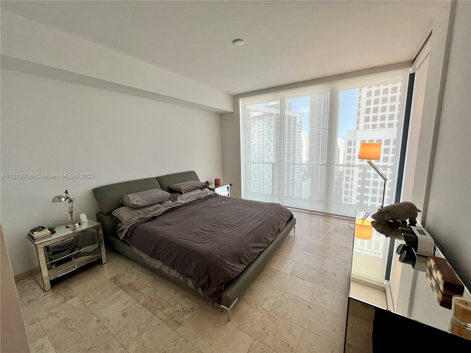 68 Southeast 6th Street, Unit 2801 Miami, FL 33131 - Photo 20 of 40 a bedroom with a bed and a window