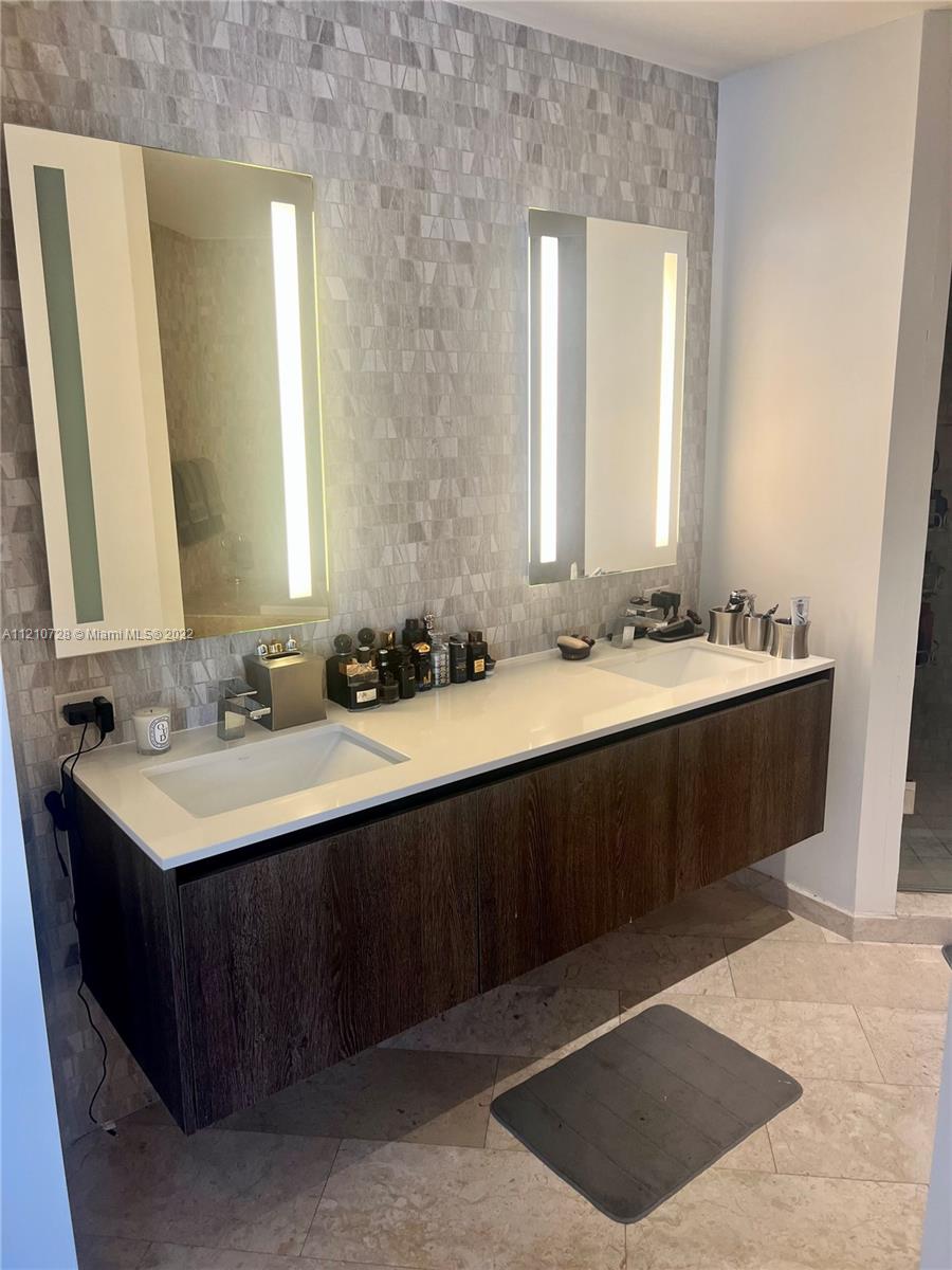 68 Southeast 6th Street, Unit 2801 Miami, FL 33131 - Photo 25 of 40 a bathroom with a sink double vanity and a mirror