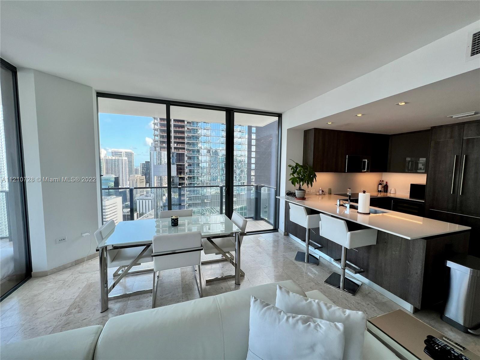 68 Southeast 6th Street, Unit 2801 Miami, FL 33131 - Photo 30 of 40 a living room with furniture and a table