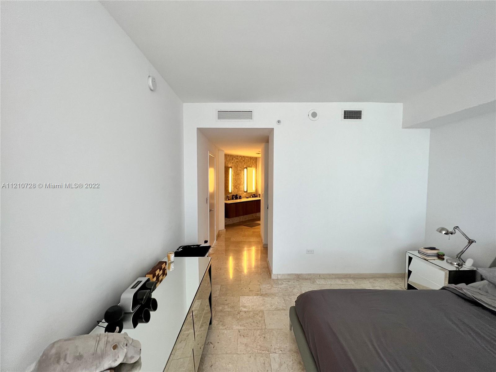 68 Southeast 6th Street, Unit 2801 Miami, FL 33131 - Photo 33 of 40 a bedroom with a bed and a window