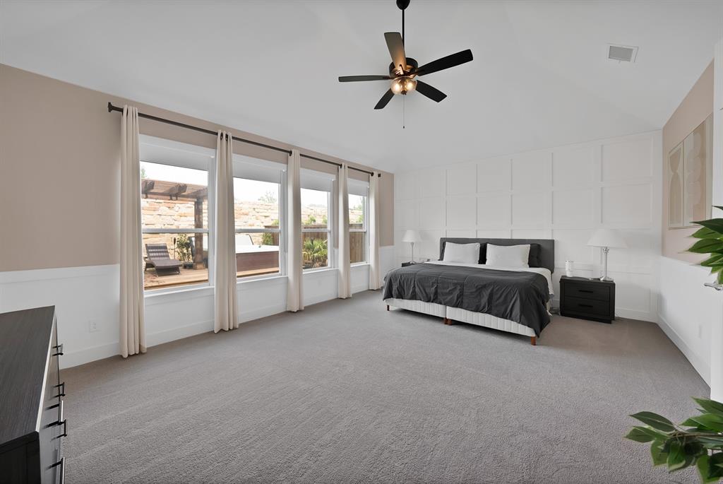 1010 Adair Road Prosper, TX 75078 - Photo 14 of 39 a spacious bedroom with a bed a couch and a window