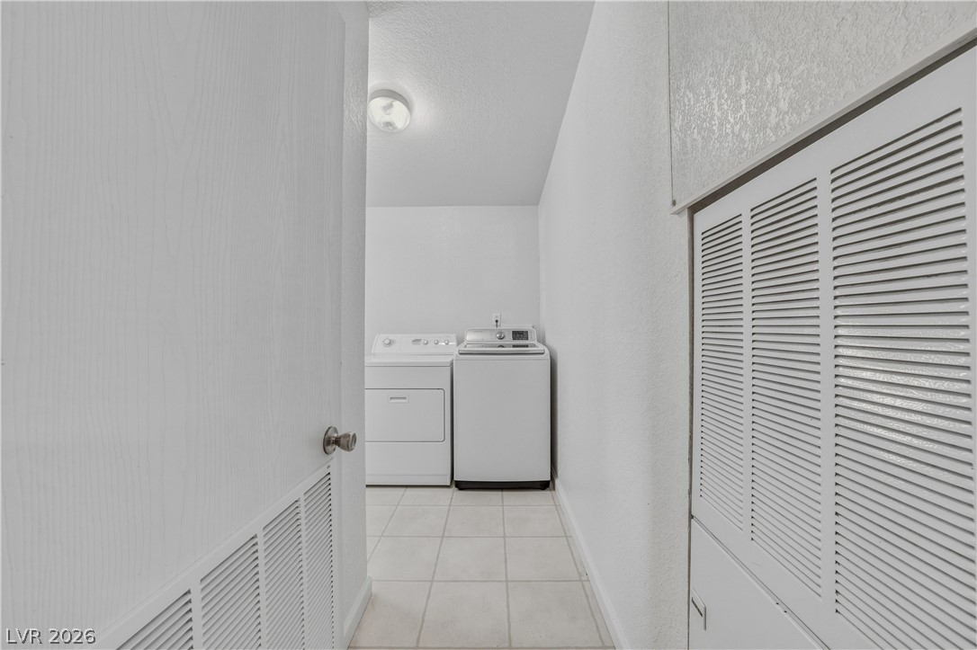 1890 West Dyer Road Pahrump, NV 89048 - Photo 17 of 40 This dedicated laundry space features practical amenities and durable flooring, ensuring convenience and ease.
