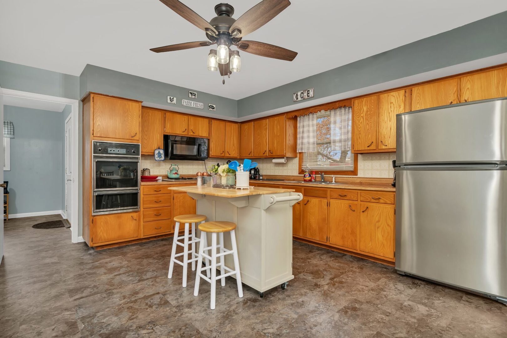 119 Davis Street Seneca, IL 61360 - Photo 8 of 21 a kitchen with stainless steel appliances granite countertop a refrigerator a sink dishwasher a stove and a refrigerator with wooden floor