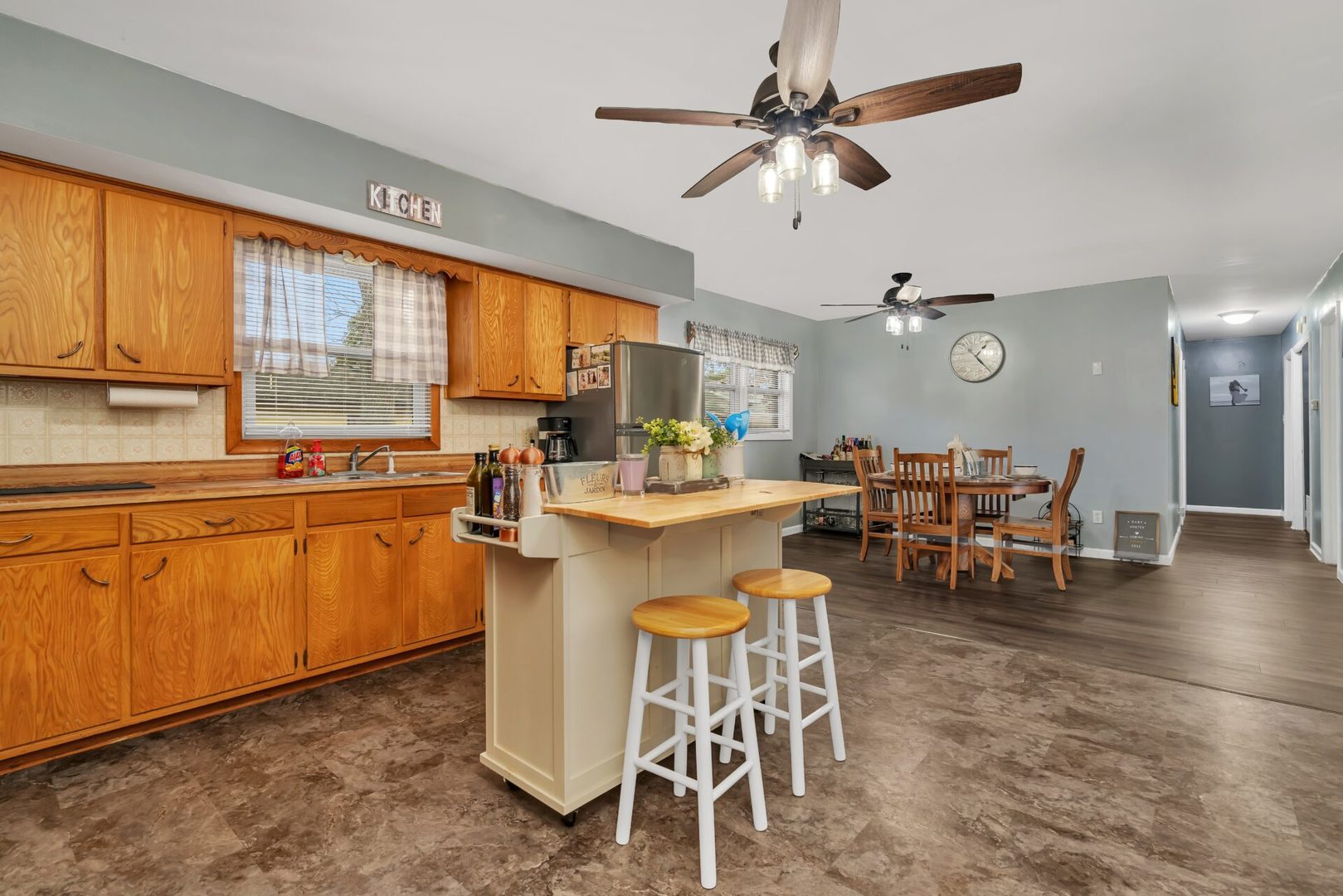 119 Davis Street Seneca, IL 61360 - Photo 9 of 21 a kitchen with a dining table chairs and white cabinets