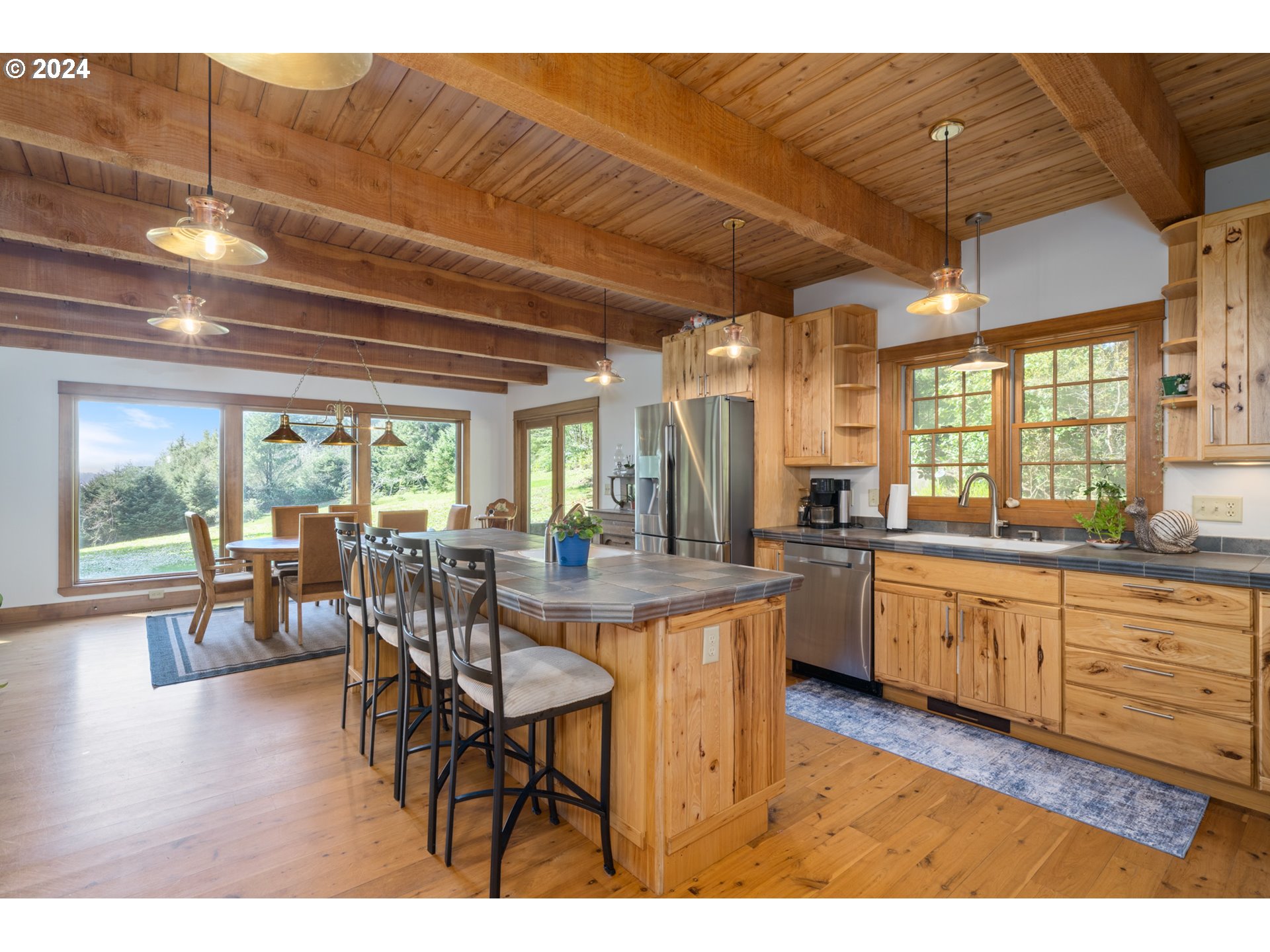 2705 Netarts Bay Drive Netarts, OR 97141 - Photo 13 of 48 a open kitchen with granite countertop a dining table chairs and white walls
