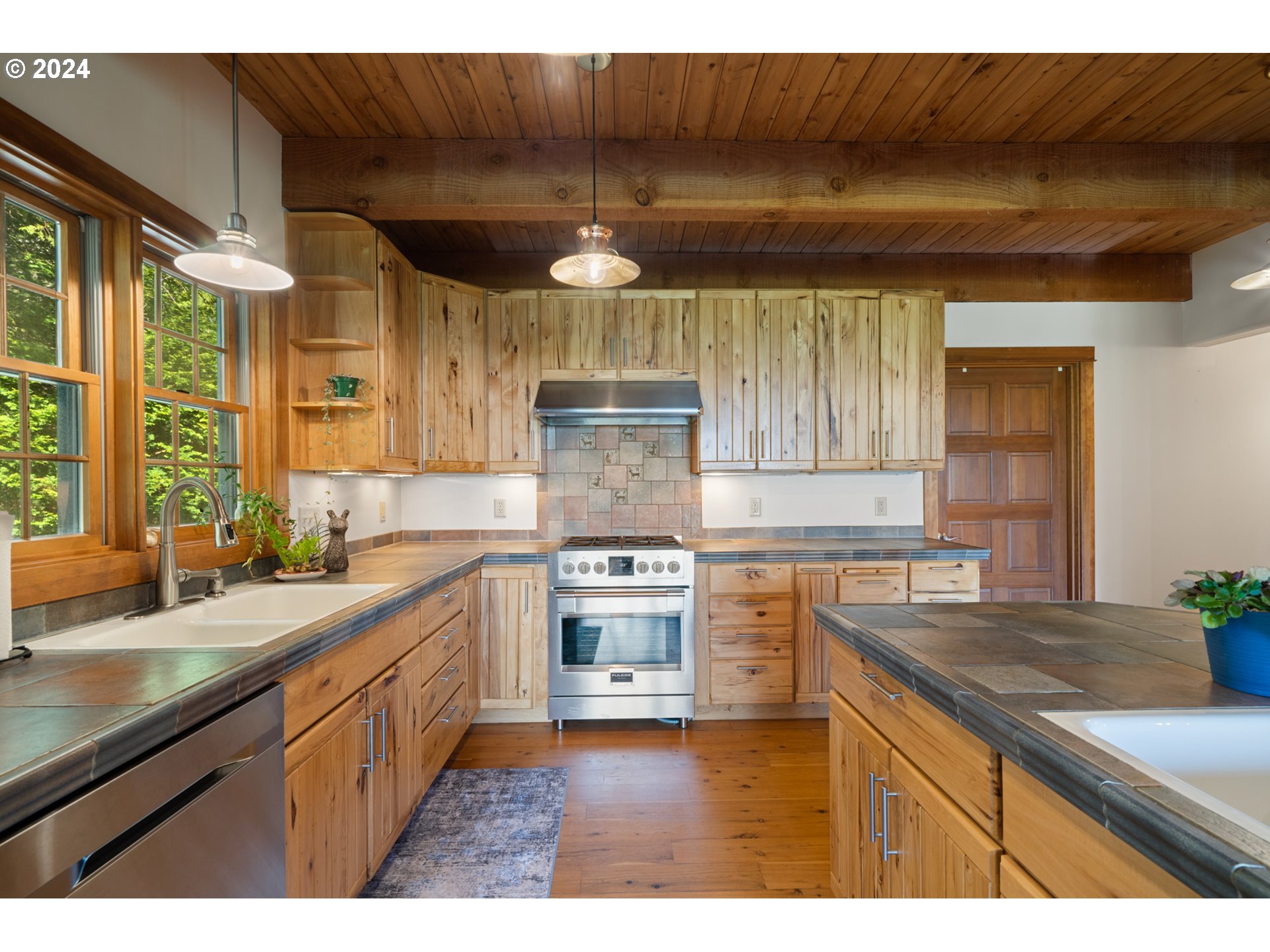 2705 Netarts Bay Drive Netarts, OR 97141 - Photo 16 of 48 a kitchen with kitchen island granite countertop a sink cabinets and stainless steel appliances