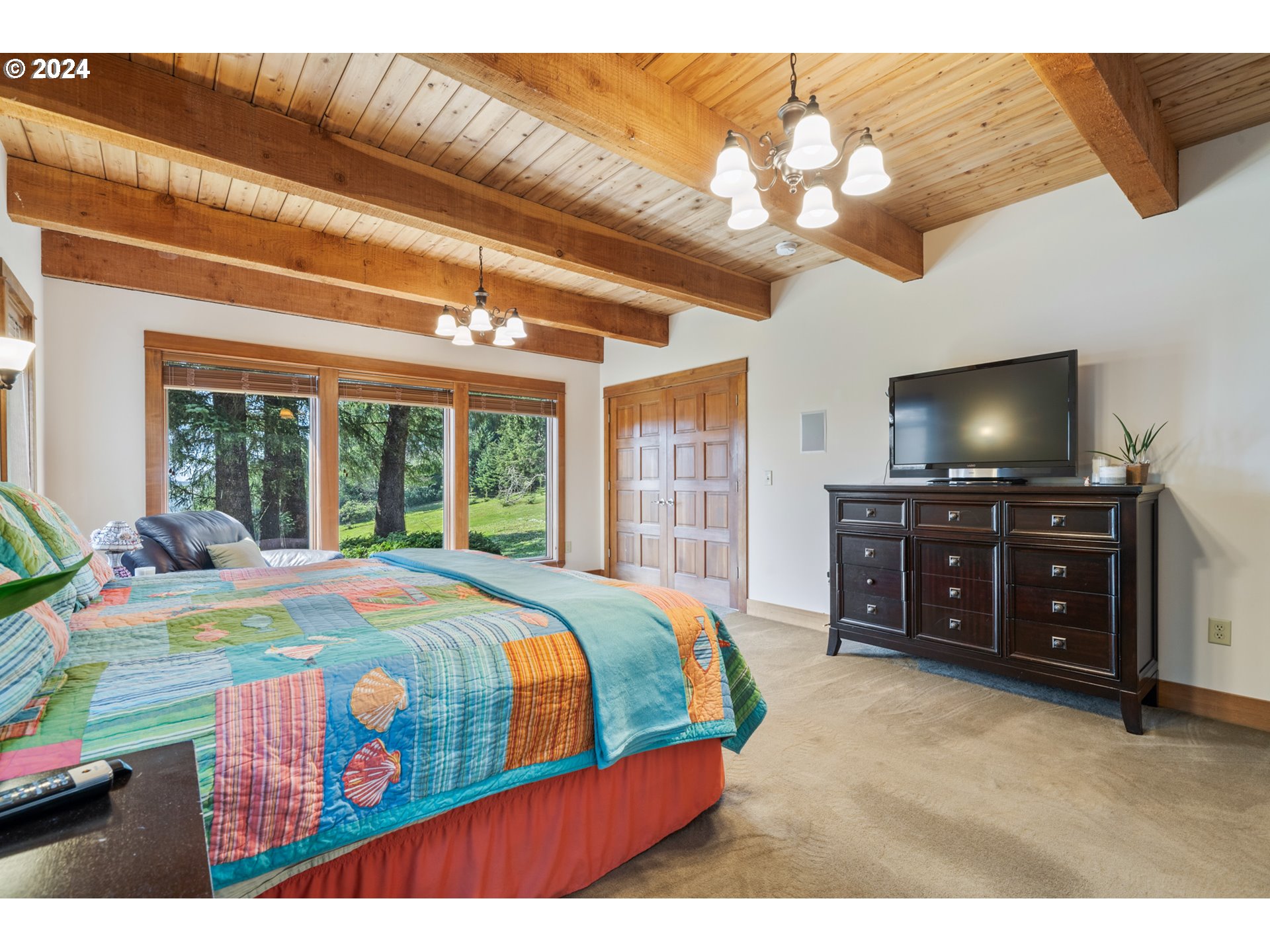 2705 Netarts Bay Drive Netarts, OR 97141 - Photo 21 of 48 a bedroom with a bed and a flat tv screen on dresser
