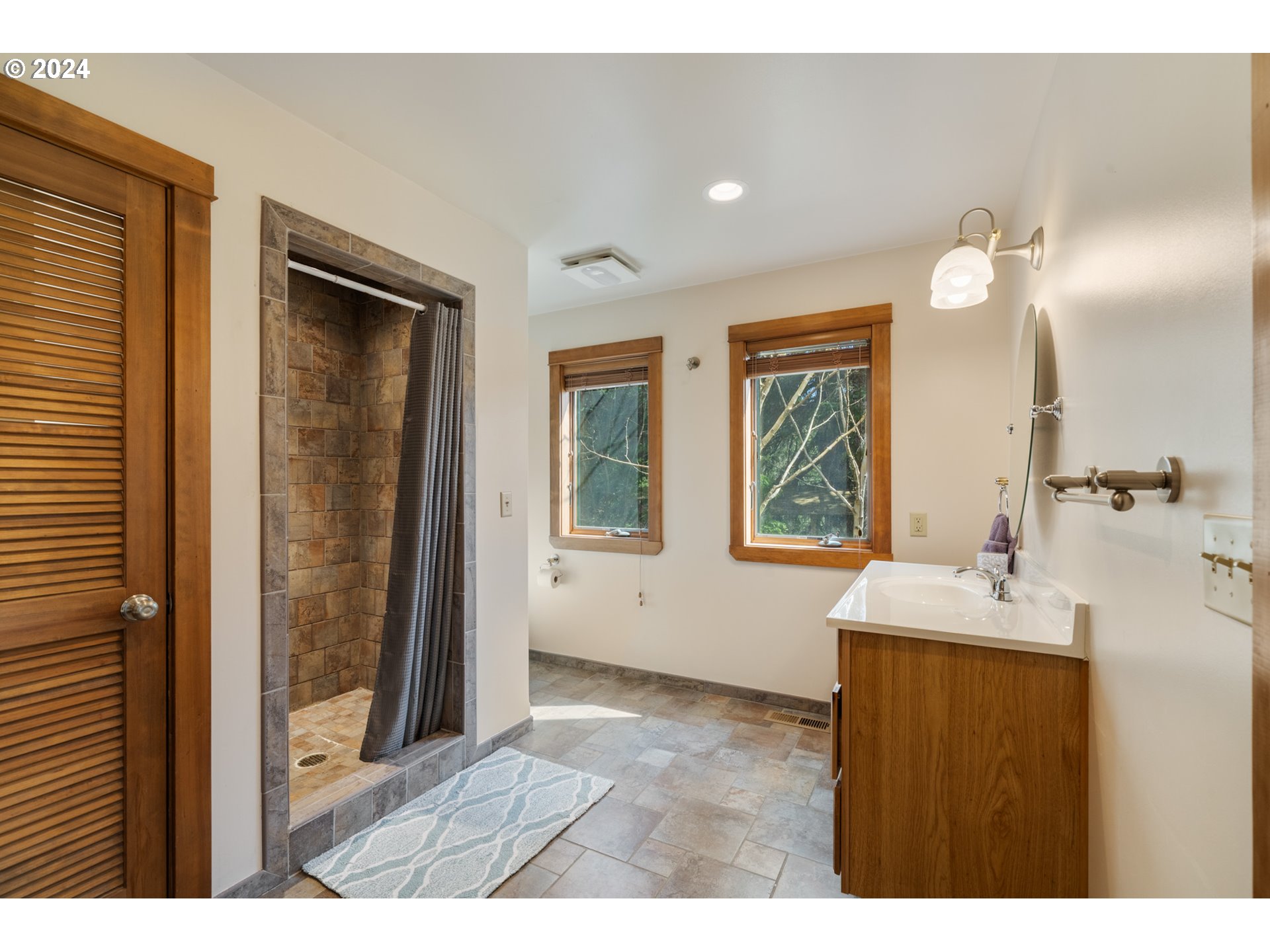 2705 Netarts Bay Drive Netarts, OR 97141 - Photo 22 of 48 a bathroom with a sink mirror and a shower