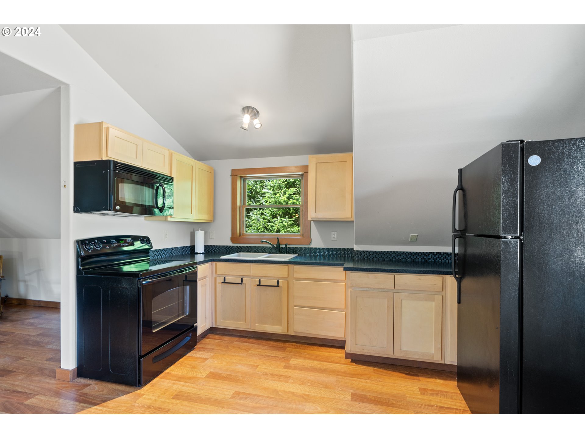 2705 Netarts Bay Drive Netarts, OR 97141 - Photo 41 of 48 a kitchen with stainless steel appliances granite countertop a stove a sink and a refrigerator