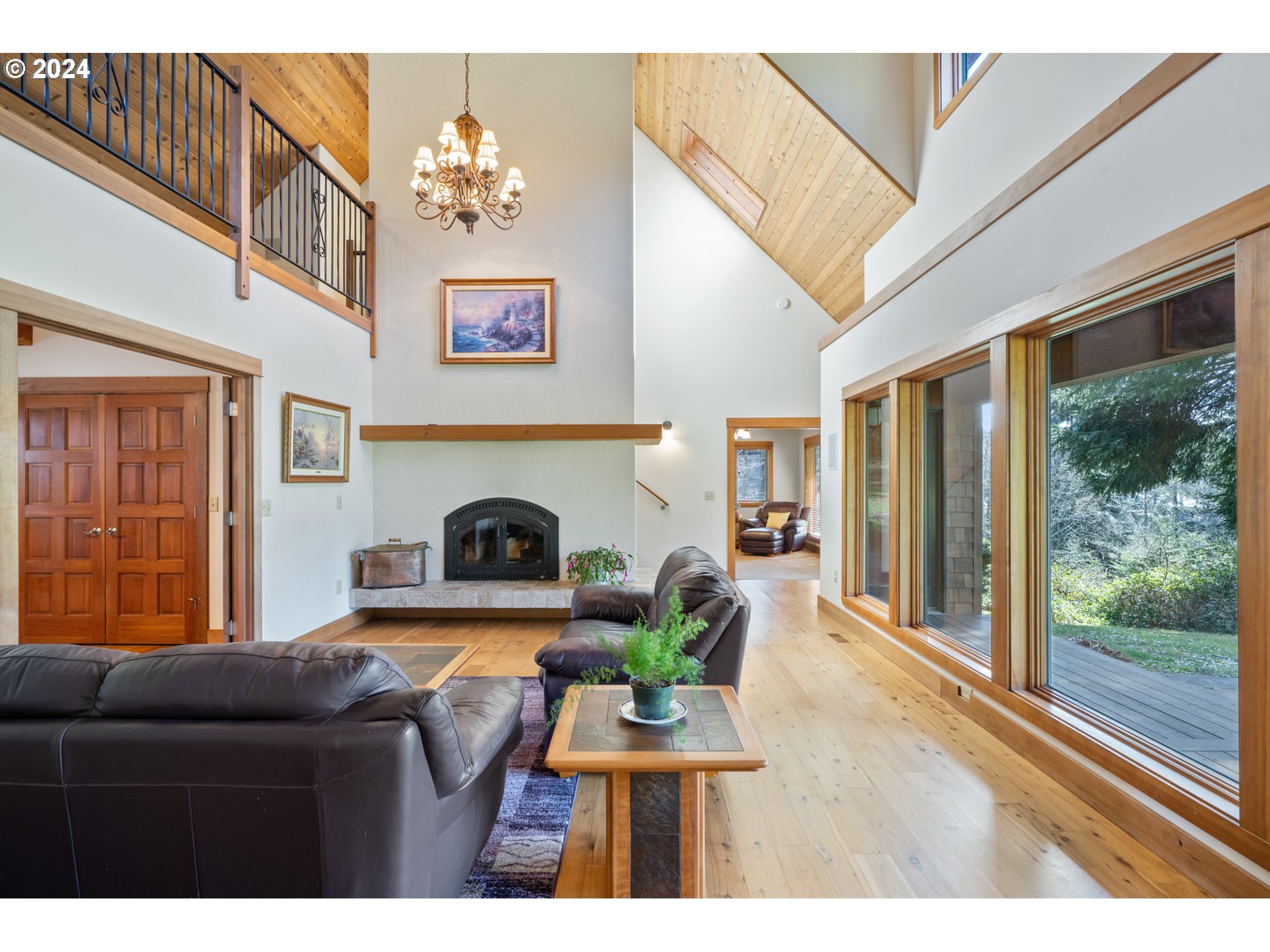 2705 Netarts Bay Drive Netarts, OR 97141 - Photo 9 of 48 a living room with furniture a fireplace and a floor to ceiling window