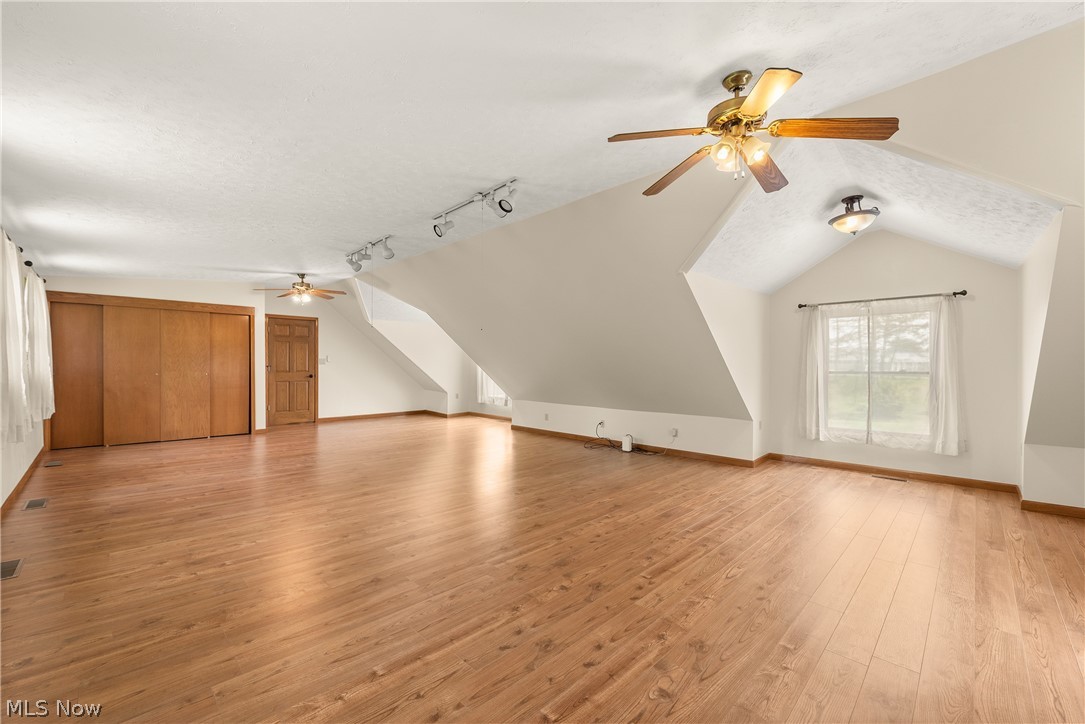 9990 Broadview Road Broadview Heights, OH 44147 - Photo 39 of 47 Bonus room featuring a ceiling fan, lofted ceiling, light wood finished floors, and a textured ceiling