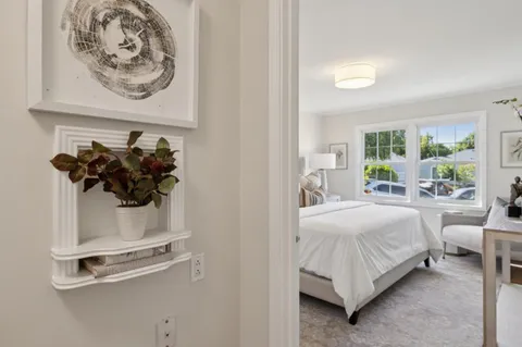 a bedroom with a bed and a mirror