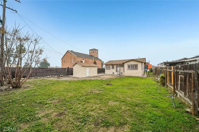 a front view of house with yard and trees