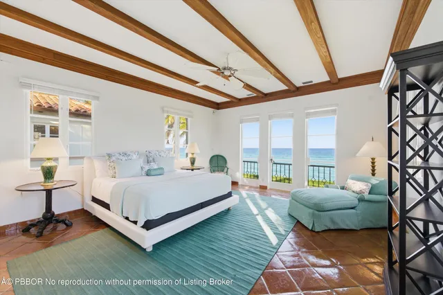 a bedroom with a bed and a large window with outer view