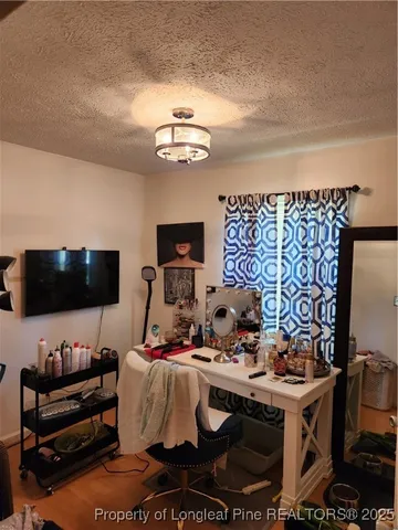a view of a livingroom with workspace and a couch