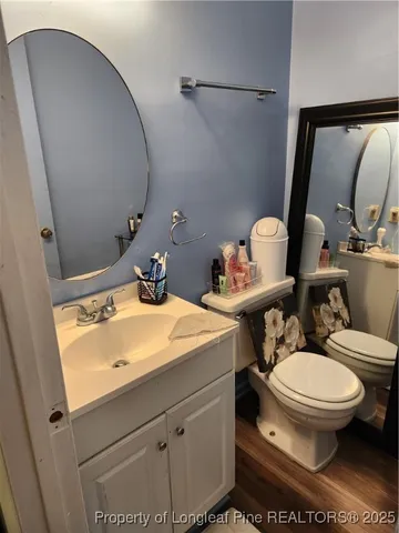 a bathroom with a sink and mirror with toilet