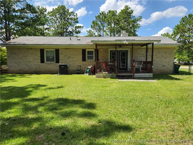 a view of a house with a yard and sitting area