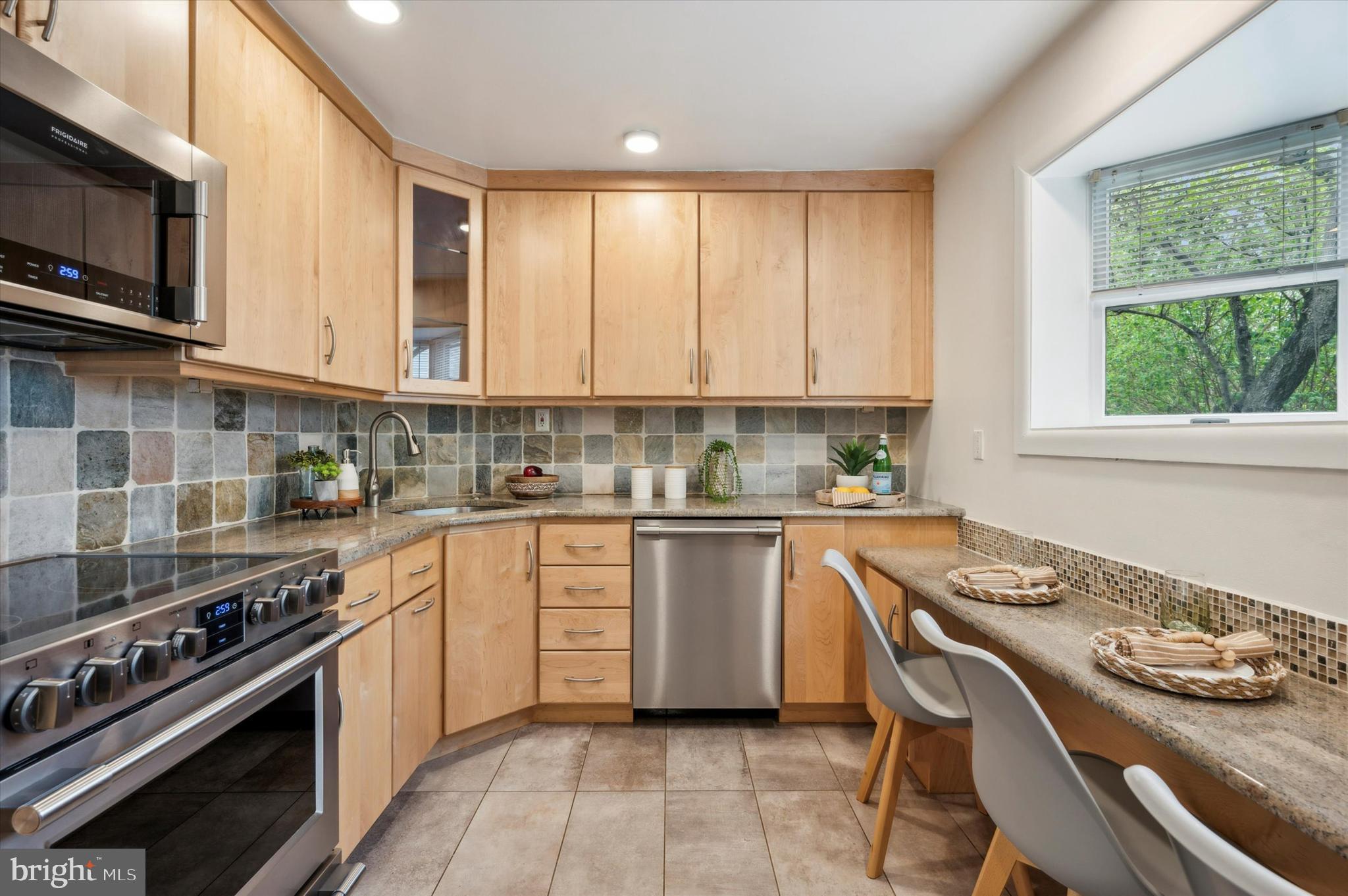 135 Cornell Road Bala Cynwyd, PA 19004 - Photo 14 of 37 a kitchen with stainless steel appliances granite countertop a stove top oven a sink dishwasher a dining table and chairs with wooden floor