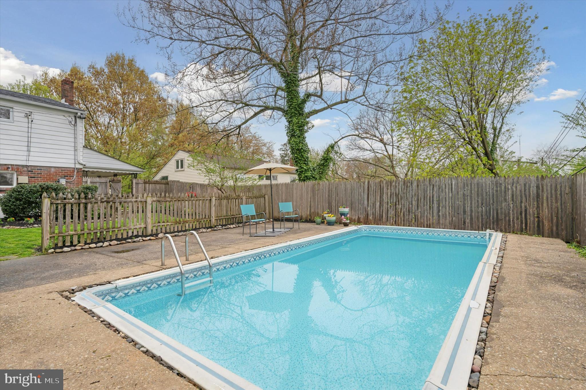 135 Cornell Road Bala Cynwyd, PA 19004 - Photo 35 of 37 a view of a swimming pool with a patio and wooden fence