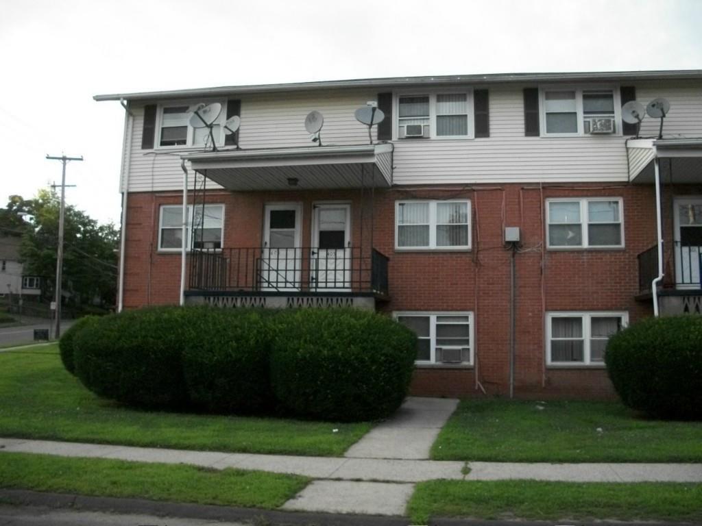 409 Mill Rock Road, Unit 409 Hamden, CT 06517 - Photo 1 of 1 a front view of a house with garden