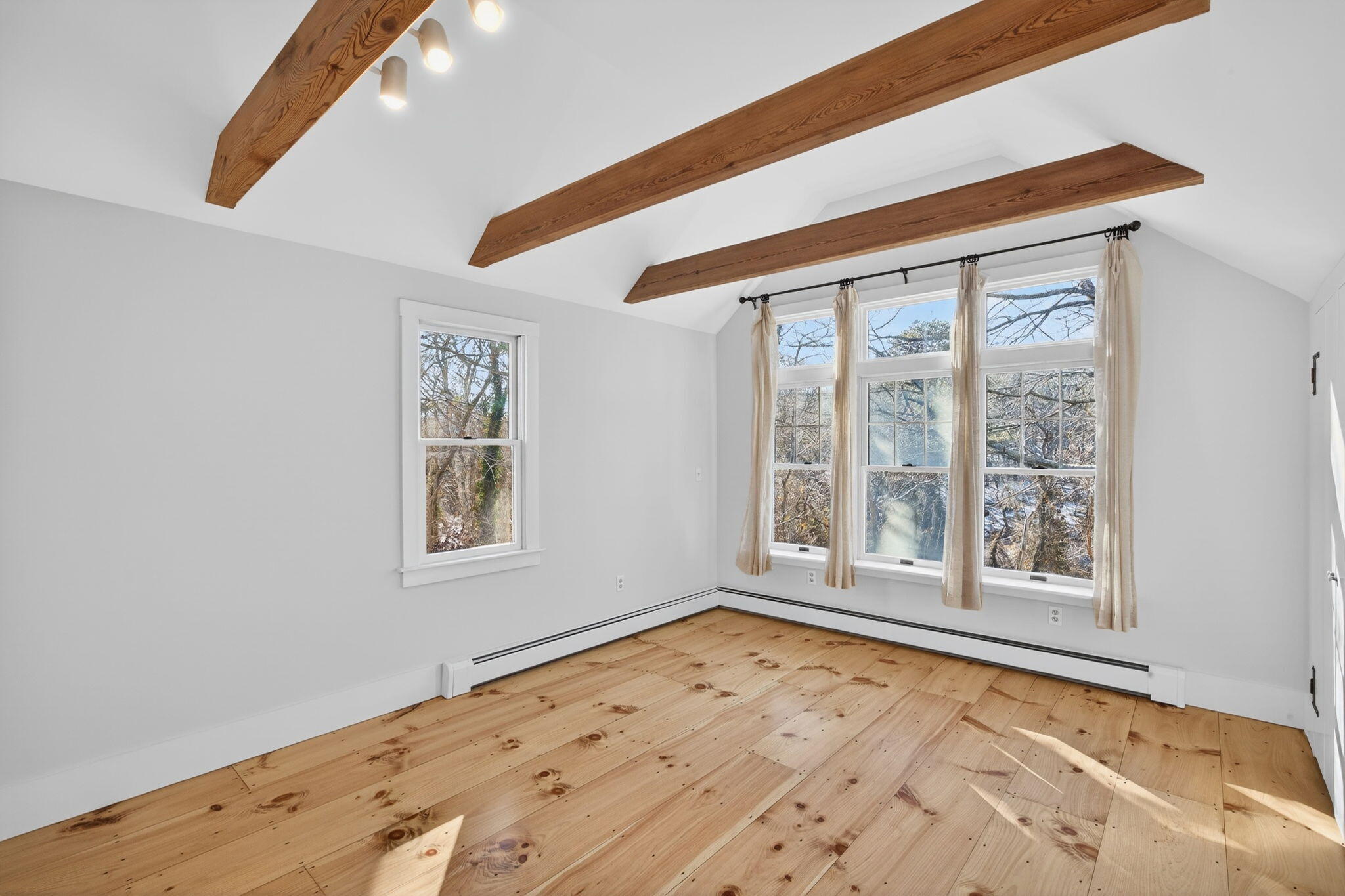 14 Bambi Way Orleans, MA 02653 - Photo 36 of 59 a view of an empty room with a window and wooden floor