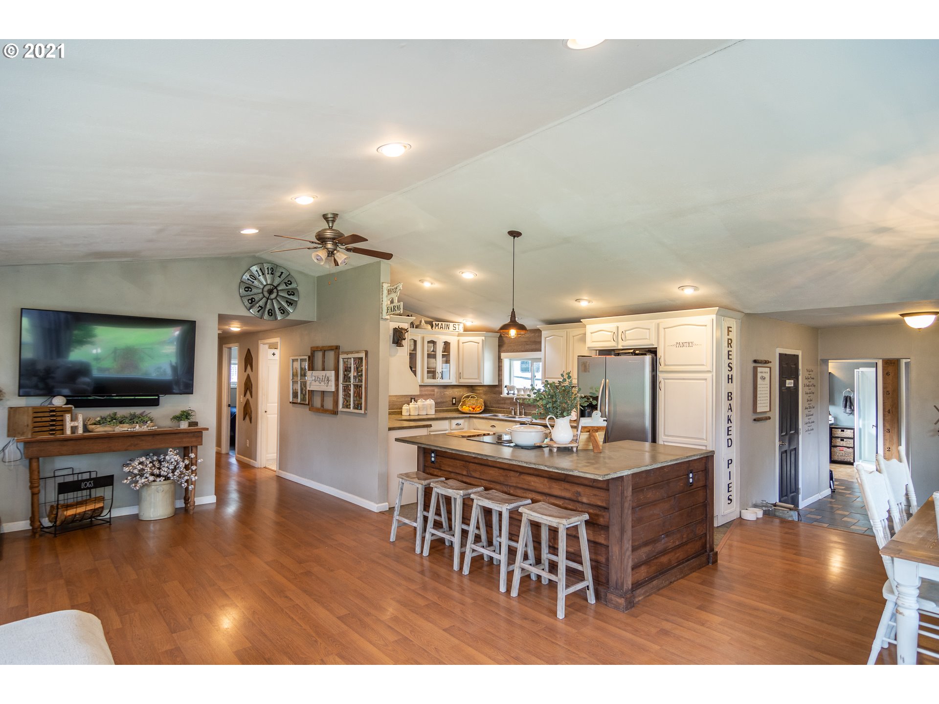 51998 Big Creek Road Myrtle Point, OR 97458 - Photo 12 of 32 a living room with kitchen island furniture and a flat screen tv