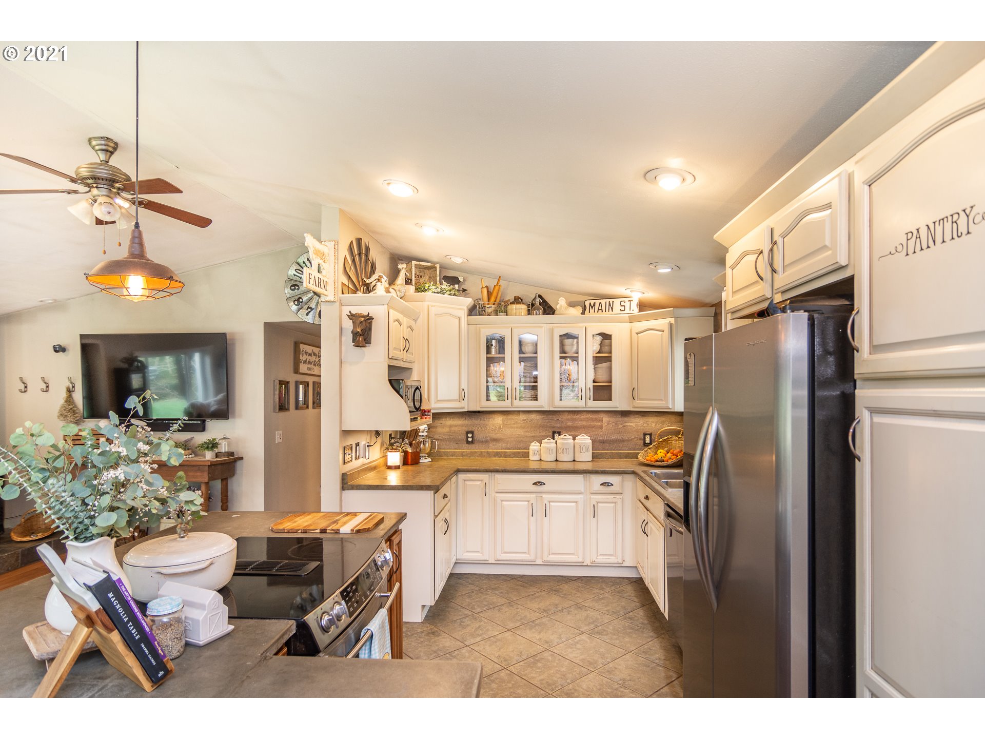 51998 Big Creek Road Myrtle Point, OR 97458 - Photo 14 of 32 a kitchen with stainless steel appliances kitchen island granite countertop a refrigerator and microwave