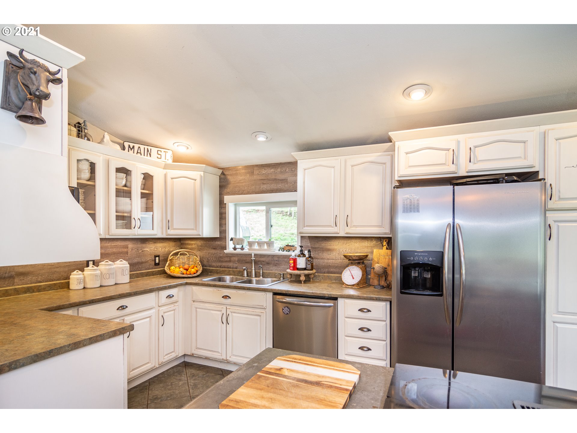 51998 Big Creek Road Myrtle Point, OR 97458 - Photo 17 of 32 a kitchen with stainless steel appliances a refrigerator sink and cabinets