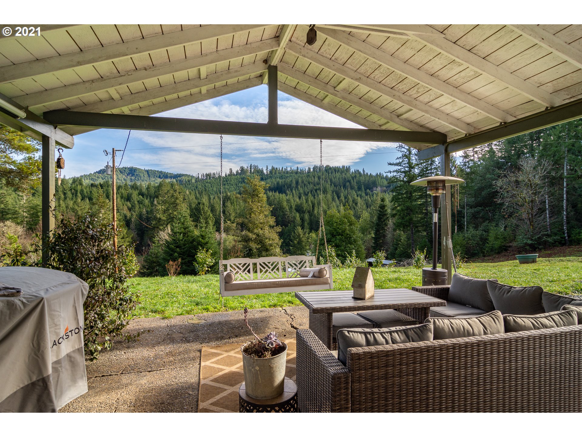 51998 Big Creek Road Myrtle Point, OR 97458 - Photo 2 of 32 a view of a patio with a table chairs and a backyard