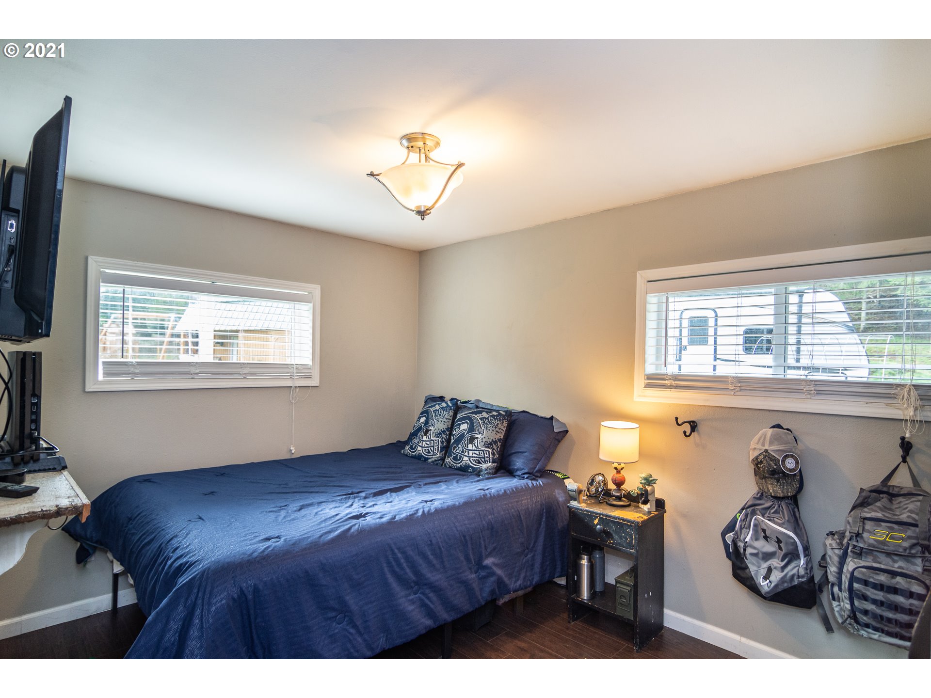 51998 Big Creek Road Myrtle Point, OR 97458 - Photo 22 of 32 a bedroom with a bed and wooden floor
