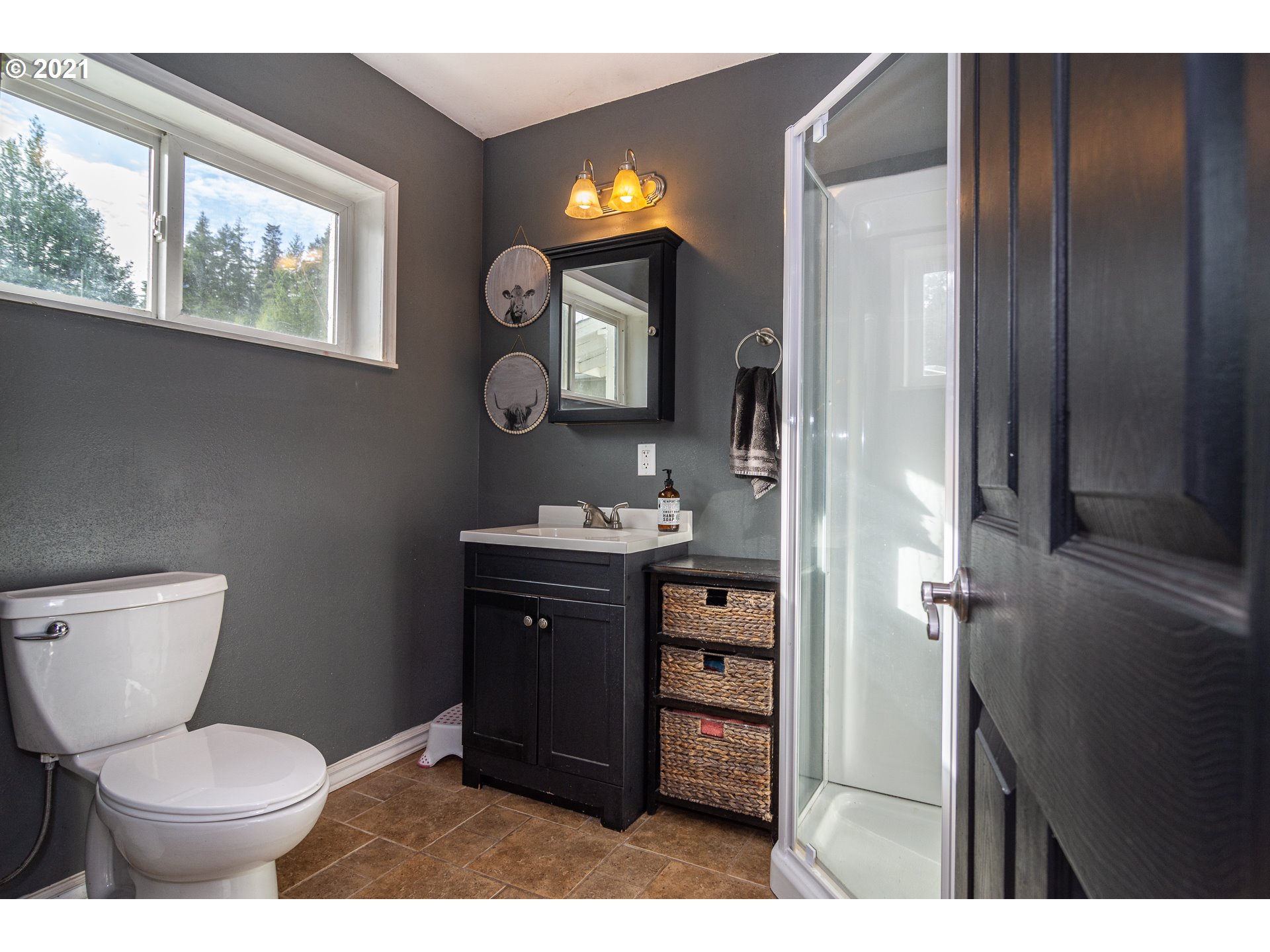 51998 Big Creek Road Myrtle Point, OR 97458 - Photo 26 of 32 a bathroom with a toilet sink vanity and mirror