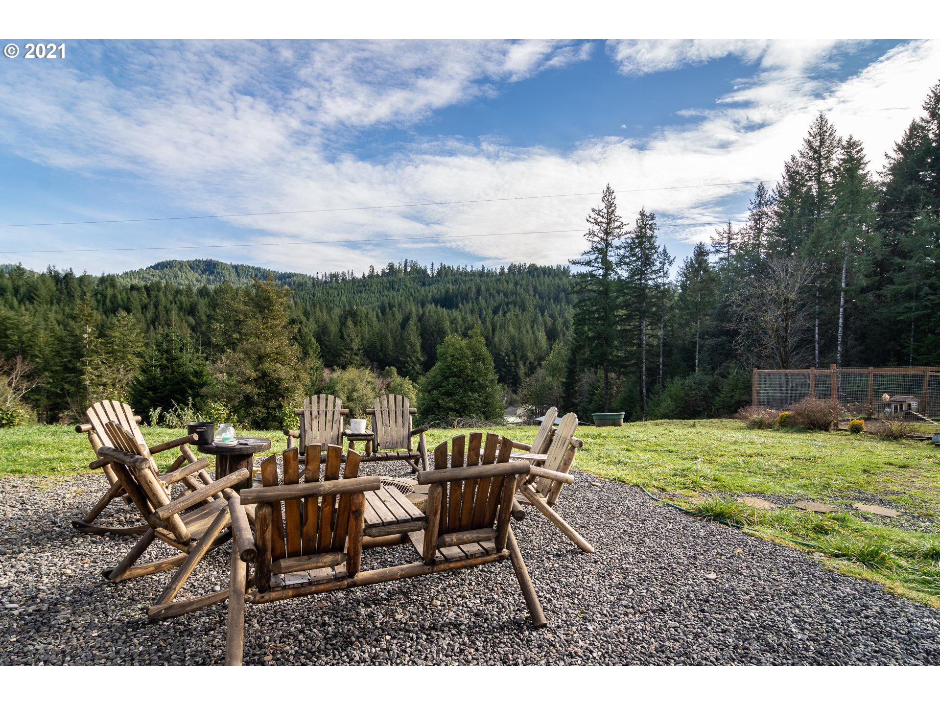 51998 Big Creek Road Myrtle Point, OR 97458 - Photo 3 of 32 a backyard of a house with table and chairs