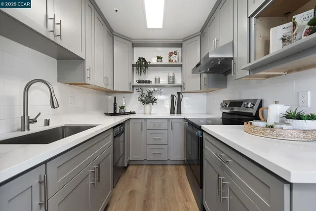 a kitchen with a sink cabinets and wooden floor