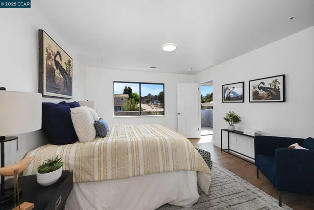 a bedroom with a large bed and a couch