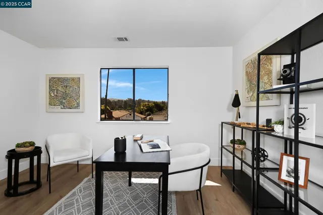 a view of a dining room with furniture and a window